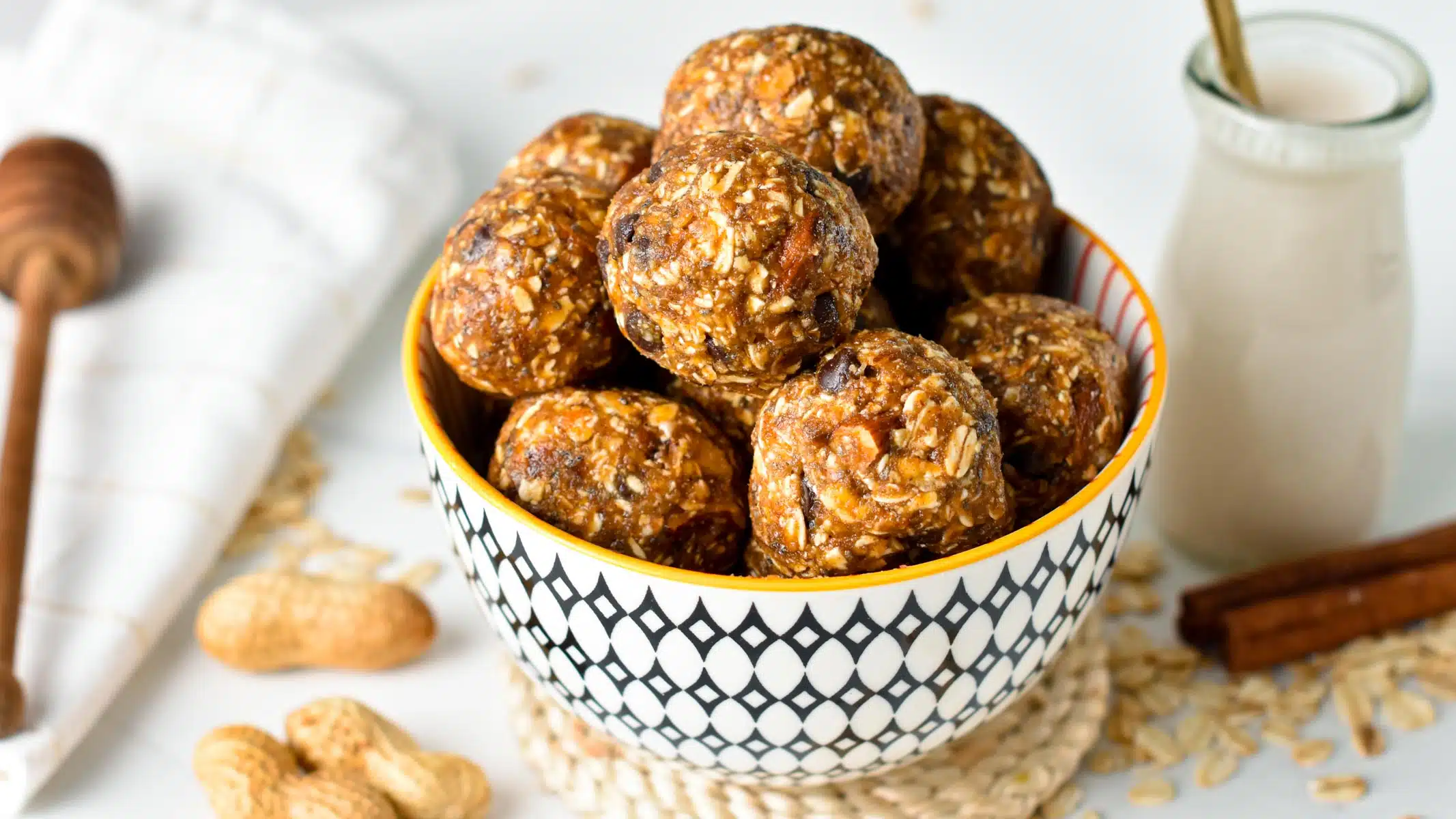 a bowl filled with no bake energy balls made from nuts, dates and called Lactation Balls