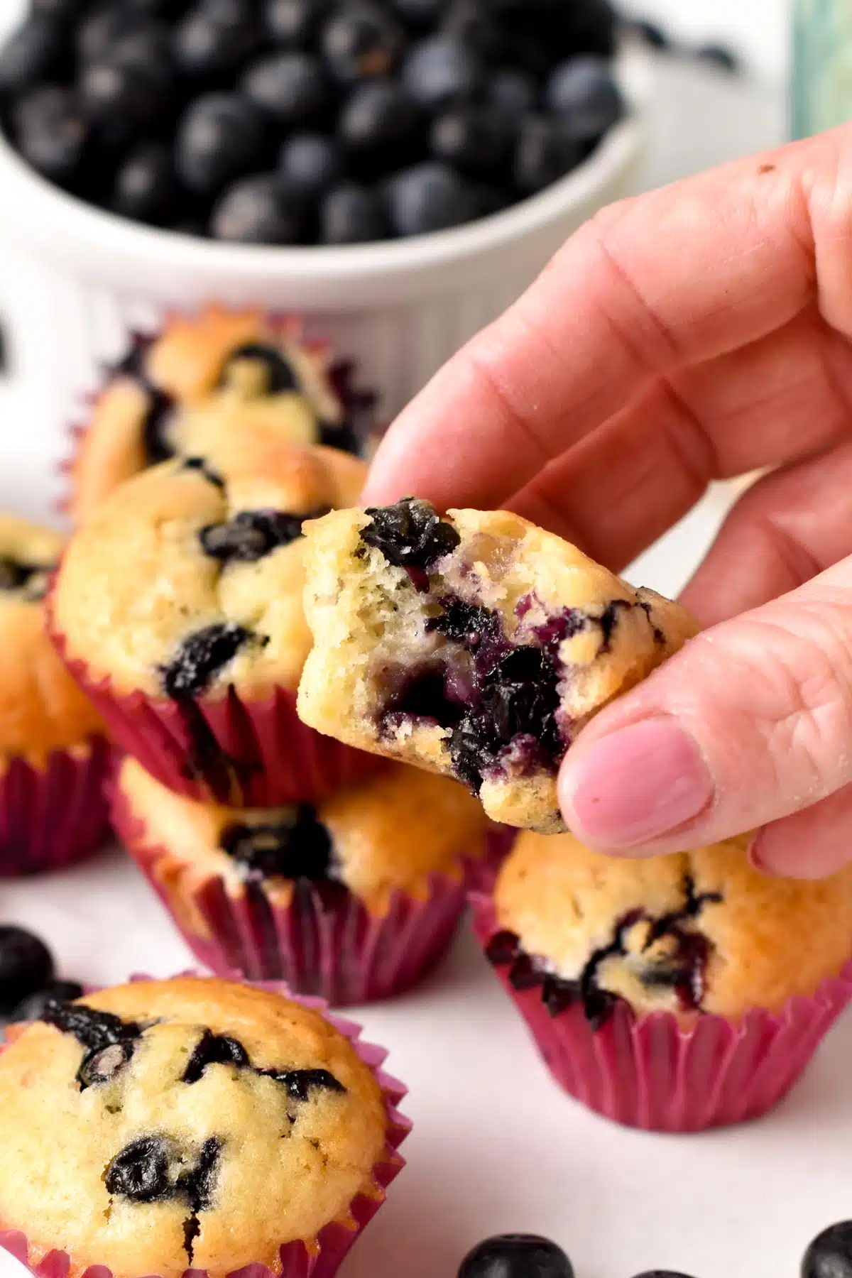 These mini blueberry muffins are tasty small-serve blueberry muffins filled with juicy blueberries and fluffy vanilla crumbs. They are perfect for kids' lunchboxes or small hands.