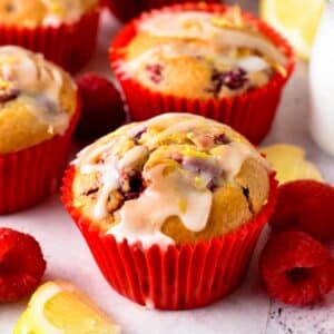 These Raspberry Lemon Muffins are easy raspberry muffins with a hint of lemon and sweet lemon glazing. A perfect fruit muffin for berry lovers.